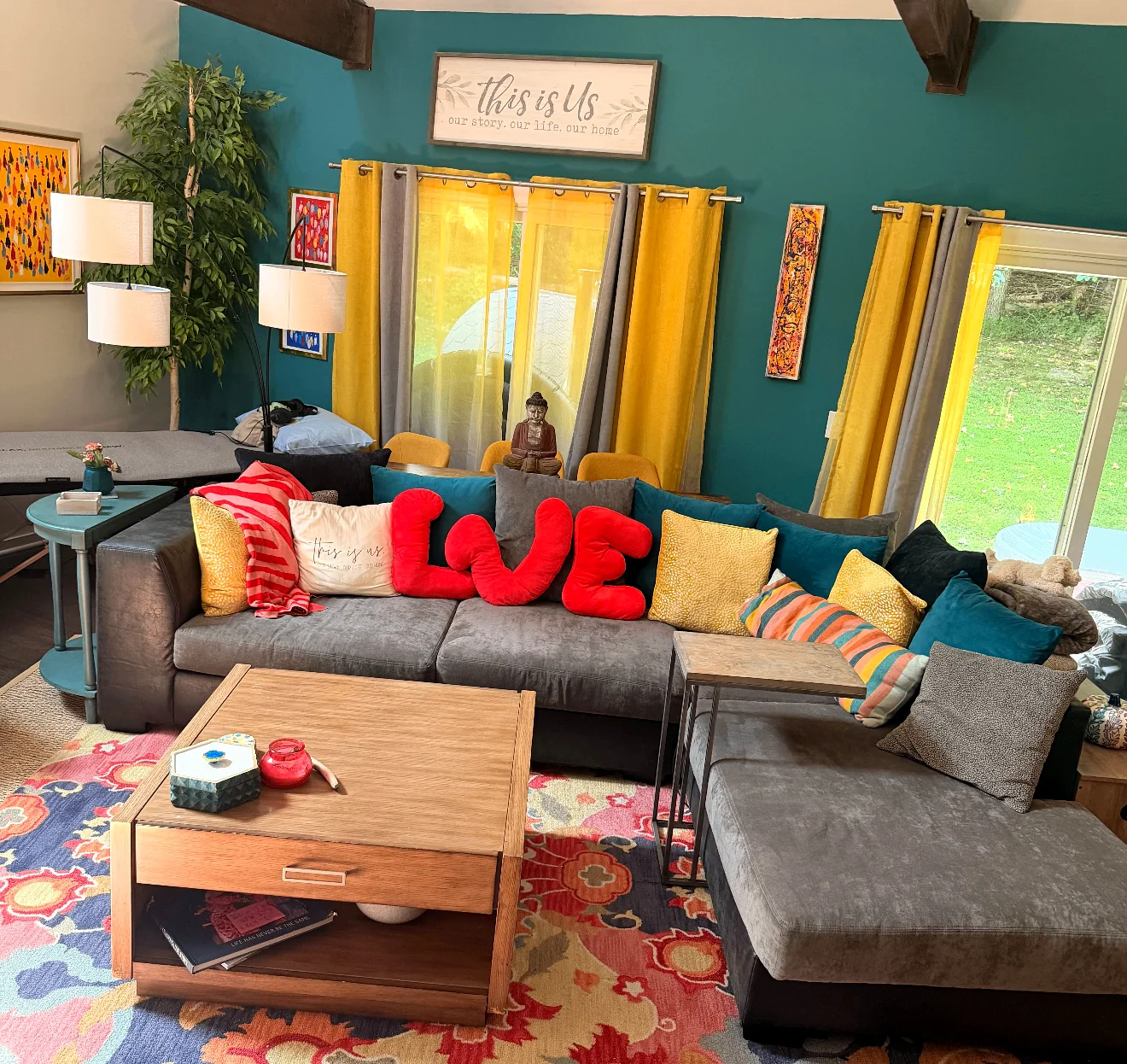 Colorful teal living room with sectional sofa and bright textiles