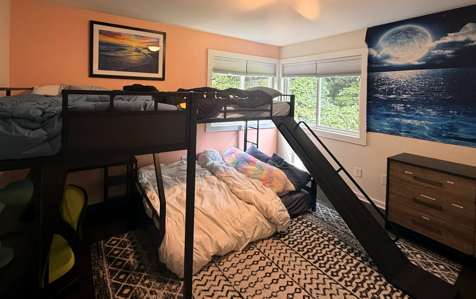 Bedroom with dark bunk beds and a slide