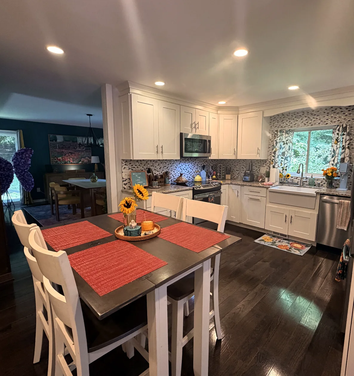 Bright kitchen with central island, stools, and white cabinetry